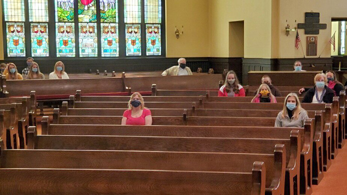 Members of the congregation wear masks and sit apart from one another during worship at First United Methodist Church of Mt. Carmel, Pa., on Sunday, May 10, 2020. Mt. Carmel was able to reopen for in-person worship after guidelines set by state government. Photo courtesy of the Rev. Kay Painter.