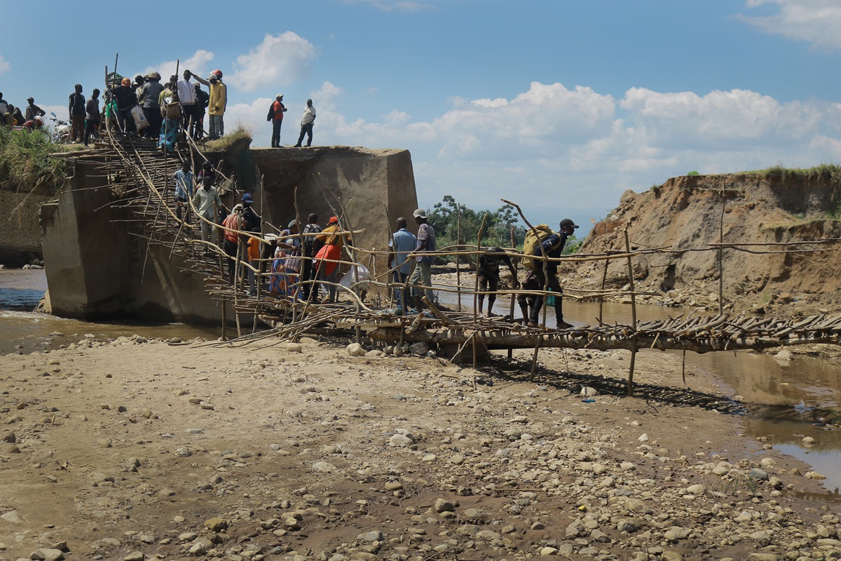 People walk over a wooden bridge built by United Methodist Men of Sange after the original bridge was washed away by mid-April flooding in Uvira, Congo. Photo by Philippe Kituka Lolonga, UM News. People walk over a wooden bridge built by United Methodist Men of Sange after the original bridge was washed away by mid-April flooding in Uvira, Congo. Photo by Philippe Kituka Lolonga, UM News.