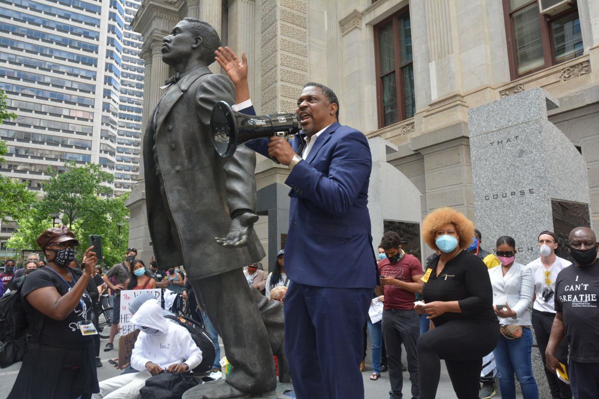The Rev. Gregory Holston speaks during a May 31 demonstration at Philadelphia City Hall in honor of George Floyd. Holston, a United Methodist pastor and adviser to Philadelphia’s district attorney, stands beside a statue of slain voting rights activist Octavius Catto. Photo by Samaria Bailey, Philadelphia Tribune. The Rev. Gregory Holston speaks during a May 31 demonstration at Philadelphia City Hall in honor of George Floyd. Holston, a United Methodist pastor and adviser to Philadelphia’s district attorney, stands beside a statue of slain voting rights activist Octavius Catto. Photo by Samaria Bailey, Philadelphia Tribune.