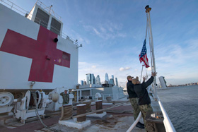 Sailors on the hospital ship USNS Comfort raise the colors while the ship is moored in New York Harbor in support of the nation's COVID-19 response efforts. United Methodist leaders are painting a sobering picture of the coronavirus impact on New York and New Jersey. “This is our new 9/11 in New York,” said New York Area Bishop Thomas J. Bickerton. Photo by Mass Communication Specialist 2nd Class Sara Eshleman, U.S. Navy.