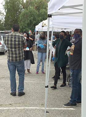 Members of Crossroads United Methodist Church, including pastor Adrienne Zackery and Compton, Calif., councilperson Emma Sharif, hand out 150 hygiene kits at "Operation Love.” The event was part of the church’s initiative to aid 3,500 citizens released from prisons and detention centers in California. Photo courtesy of Crossroads United Methodist Church.