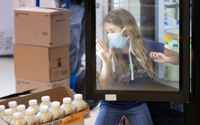 Volunteer Trinley Gibson, 9, loads perishable items into a cooler at the Branch of Nashville emergency food assistance program at Antioch (Tenn.) United Methodist Church. Photo by Mike DuBose, UM News.