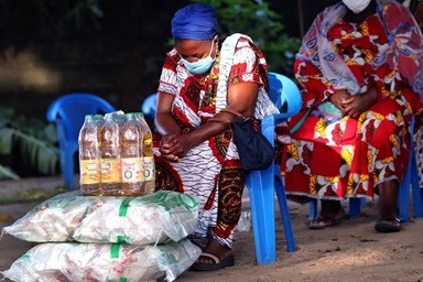 Akou Logbo bows her head as Bishop Benjamin Boni prays for the victims of flooding in Abidjan, Côte d’Ivoire, and the COVID-19 pandemic. She is one of 300 widows whose businesses were curtailed by the COVID-19-related lockdown. They received donations of food and non-food items worth $30,000 funded by the United Methodist Committee on Relief. Photo by Isaac Broune, UM News. Akou Logbo bows her head as Bishop Benjamin Boni prays for the victims of flooding in Abidjan, Côte d’Ivoire, and the COVID-19 pandemic. She is one of 300 widows whose businesses were curtailed by the COVID-19-related lockdown. They received donations of food and non-food items worth $30,000 funded by the United Methodist Committee on Relief. Photo by Isaac Broune, UM News.