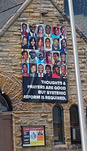 A banner promoting systemic reform to address racial issues hangs on the wall of Cass Community United Methodist Church in Detroit. Photo by Cortez Perry.