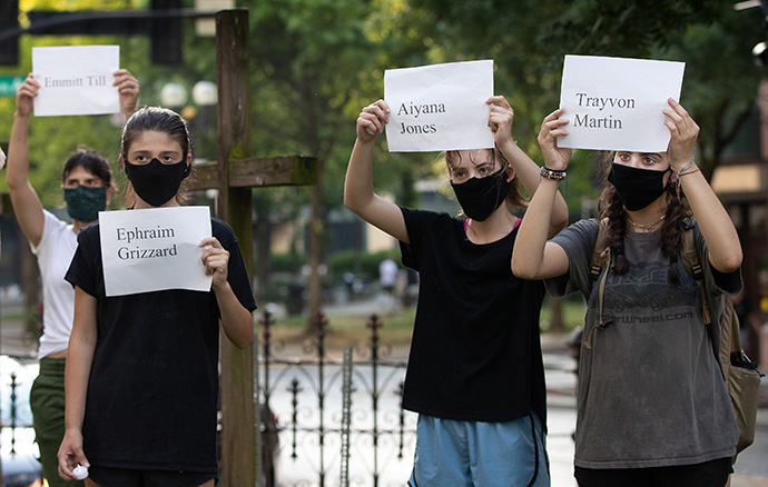 People gather in the courtyard of McKendree United Methodist Church in Nashville, Tenn., during a June 4 prayer vigil to grieve and remember people lost to acts of racism. They are holding signs in honor of victims of racial violence. File photo by Mike DuBose, UM News.