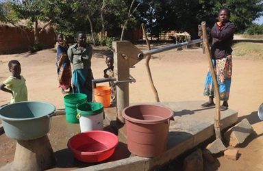 Veronika Mwale (right) pumps water from a borehole in Thako village in Mchinji, Malawai. The borehole, which supplies water for three villages, was built through a partnership between Ankeny United Methodist Church in Ankeny, Iowa, and the Malawi Provisional Conference. Photo by Francis Nkhoma, UM News. Veronika Mwale (right) pumps water from a borehole in Thako village in Mchinji, Malawai. The borehole, which supplies water for three villages, was built through a partnership between Ankeny United Methodist Church in Ankeny, Iowa, and the Malawi Provisional Conference. Photo by Francis Nkhoma, UM News.