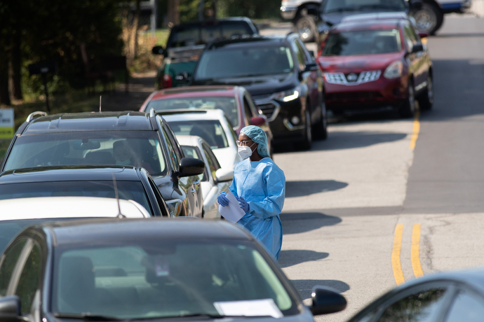 Lashunda Collins distributes paperwork to people waiting for a COVID-19 test at a drive-thru site offered by Meharry Medical College at St. Luke Christian Methodist Episcopal Church in Nashville. Photo by Mike DuBose, UM News.