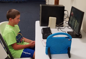 A student uses a computer at Robbinsville United Methodist Church in North Carolina. The church is providing Internet access to students. Photo by the Rev. Eric Reece.