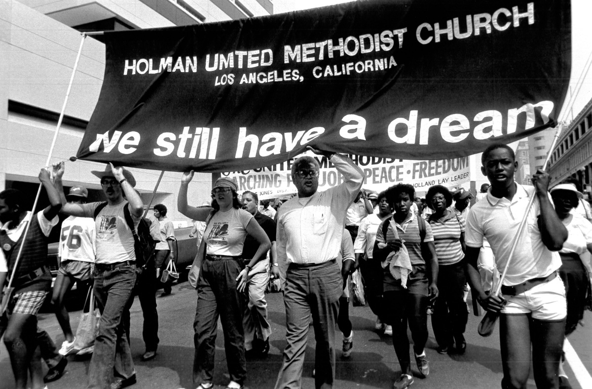 The Rev. James Lawson (center) helps lead the March for Peace, Jobs and Freedom in Washington in 1984. File photo by John C. Goodwin, Board of Global Ministries. The Rev. James Lawson (center) helps lead the March for Peace, Jobs and Freedom in Washington in 1984. File photo by John C. Goodwin, Board of Global Ministries.