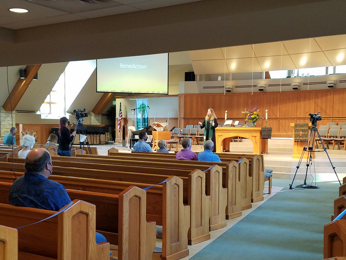 The Rev. Amy Lippoldt leads worship at St. Paul’s United Methodist Church Papillion in Nebraska. About 35 people attended the first services back in the sanctuary on Aug. 16. Photo by the Rev. Rebecca Hjelle.