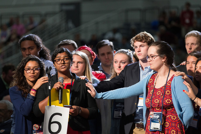 Ann Jacob is surrounded by other young people as she reads a statement on church unity during the 2016 United Methodist General Conference in Portland, Ore. File photo by Mike DuBose, UM News.