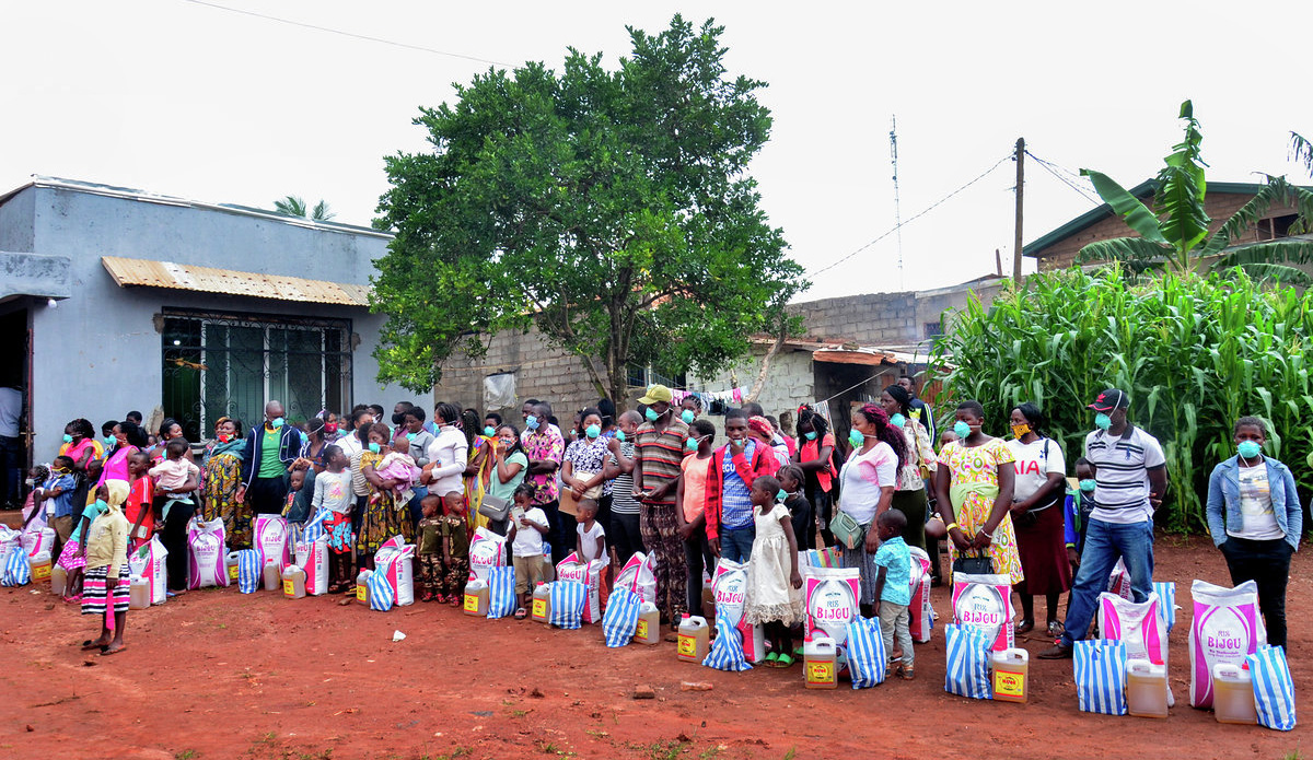 Internally displaced people line up to collect food at Ebenezer Community United Methodist Church in Yaounde, Cameroon. With a grant from the United Methodist Committee on Relief, the church distributed food and other aid to those struggling during the coronavirus pandemic. Photo courtesy Vischo Image.
