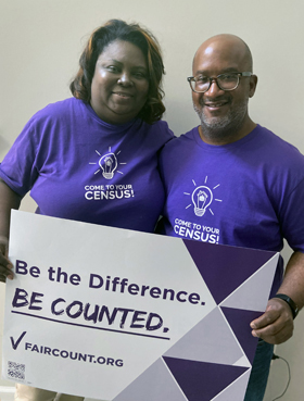 The Rev. Ralph Thompson (right), senior pastor of Columbia Drive United Methodist Church, and Taressa Thompson, the church’s first lady, stand with a Fair Count sign and “Come To Your Census!” T-shirts. The two are working with the nonpartisan nonprofit to make sure people get counted in the census. Photo courtesy of Taressa Thompson.