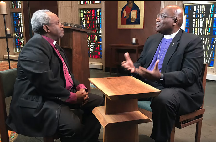 United Methodist Bishop Gregory Palmer (right) and The Episcopal Church’s presiding bishop, Michael Curry, discuss full communion between the two denominations in 2019. The proposed agreement is on hold for now because of disruptions related to COVID-19. File screenshot from video courtesy of the Council of Bishops of The United Methodist Church.