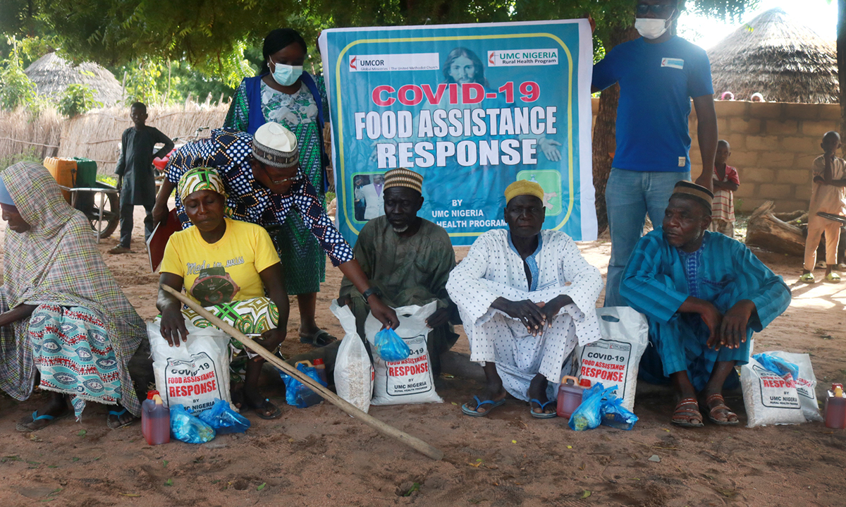 Beneficiaries in Mutum-Daya in the Wurkun Central District in Nigeria receive rice, beans, Maggi seasoning and salt as part of The United Methodist Church’s COVID-19 outreach. The Nigeria Episcopal Area received a Sheltering in Love grant from the UMCOR COVID-19 Response Fund. Photo by Richard Fidelis, UM News. 