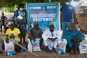 Beneficiaries in Mutum-Daya in the Wurkun Central District in Nigeria receive rice, beans, Maggi seasoning and salt as part of The United Methodist Church's COVID-19 outreach. The Nigeria Episcopal Area received a Sheltering in Love grant from the UMCOR COVID-19 Response Fund. Photo by Richard Fidelis, UM News.