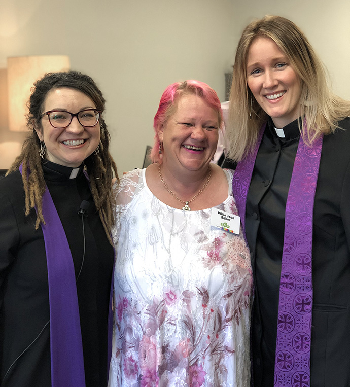 Billie Jean Baker is flanked by the Rev. Rachel Baughman (left) and the Rev. Mara Morhouse of Oak Lawn United Methodist Church, at a pre-pandemic gathering. Baker used to be homeless, and often slept outside the Dallas church. Baughman, senior pastor, credits Baker with helping lead Oak Lawn United Methodist to open its doors more widely to unsheltered persons. Photo courtesy of Oak Lawn United Methodist Church.