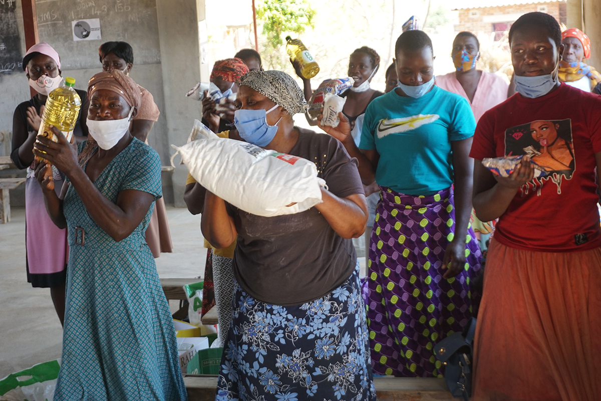 A group of beneficiaries in the Goromonzi Circuit in Harare, Zimbabwe, celebrates after receiving food hampers provided through a United Methodist Committee on Relief Sheltering in Love grant. More than 7 million people in Zimbabwe are facing food insecurity in 2020, according to the World Food Program. Photo by Kudzai Chingwe, UM News.  A group of beneficiaries in the Goromonzi Circuit in Harare, Zimbabwe, celebrates after receiving food hampers provided through a United Methodist Committee on Relief Sheltering in Love grant. More than 7 million people in Zimbabwe are facing food insecurity in 2020, according to the World Food Program. Photo by Kudzai Chingwe, UM News.