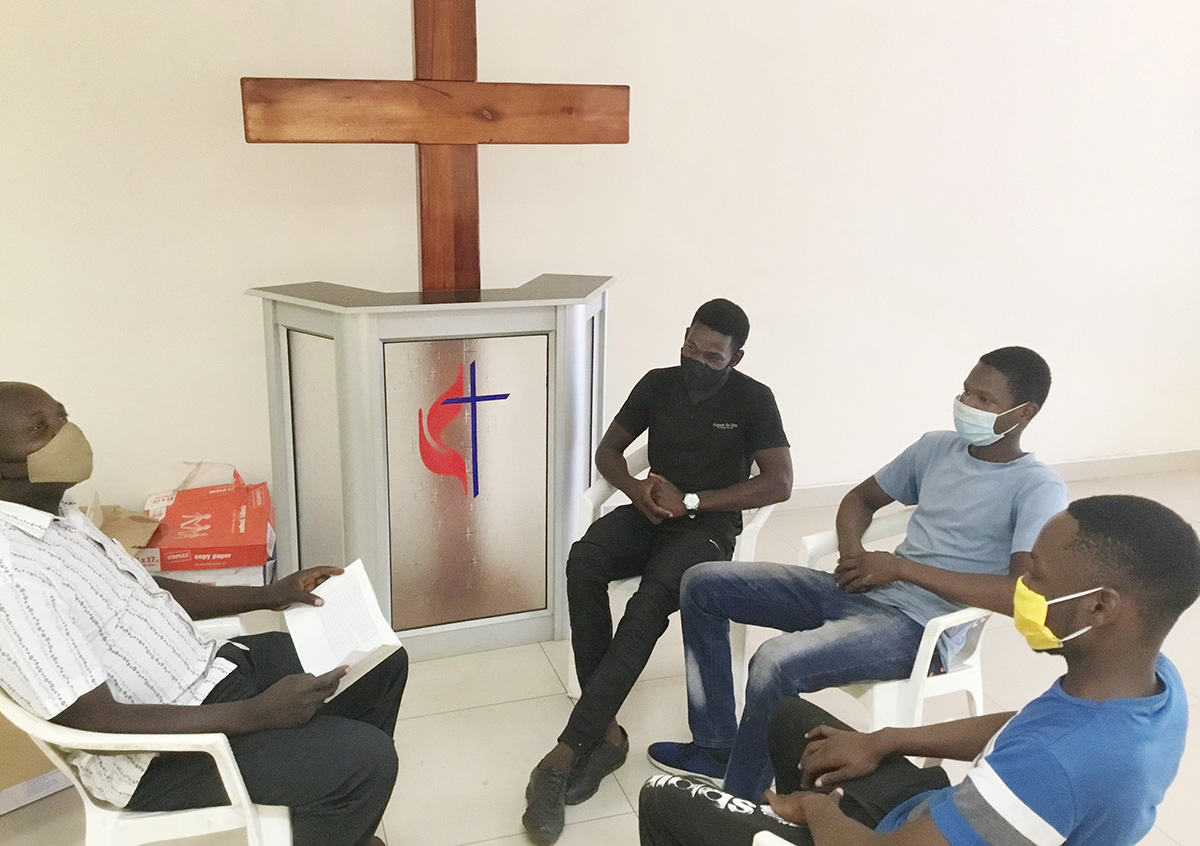 The Rev. John Makaniko (left) gathers in fellowship with teenage members from Hatfield United Methodist Church circuit in Harare, Zimbabwe. Makaniko said young people are not immune to the stress and anxiety of COVID-19. Photo by Chenayi Kumuterera, UM News. 