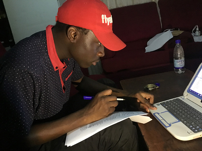 Tatenda Kambarami, 28, studies at his home during the COVID-19 lockdown. The pandemic has left many young people struggling to meet exam requirements and worried about their futures. Photo by Chenayi Kumuterera, UM News.