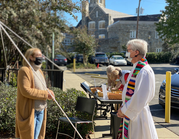 The Rev. James Howell, senior pastor at Myers Park United Methodist Church in Charlotte, N.C., greets a member outside the church where a communion service was held with social distancing. Photo by Sarah Gibson.