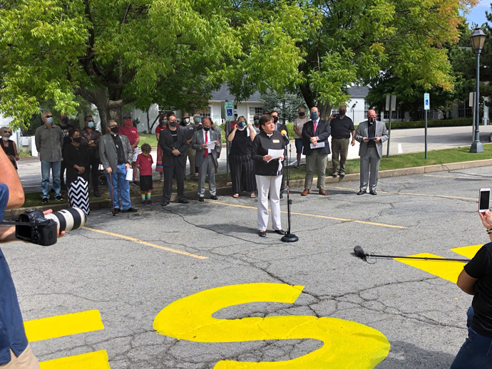 The Rev. Kathy Brown, pastor of St. Paul's United Methodist Church in Tulsa, Okla., speaks at the church, which has painted “Black Lives Matter” on its parking lot. Photo courtesy of the Rev. Twila Gibbens.