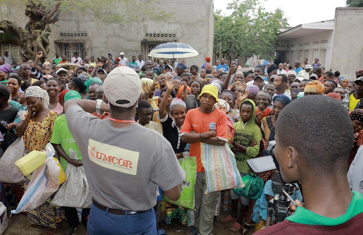 Jean Tshomba, coordinator of UMCOR's disaster management office in eastern Congo, speaks to the crowd before helping to distribute food and other items to more than 500 survivors of flooding in Uvira, Congo. Photo by Philippe Kituka Lolonga, UM News.