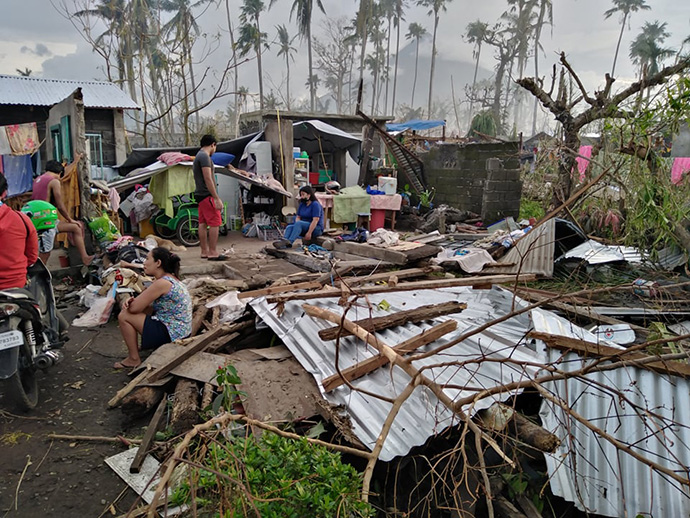 Survivors gather after Super Typhoon Rolly hit Tabaco City, Philippines. The storm damaged or destroyed the homes of six families who belong to The Living Stone United Methodist Church there. Photo courtesy of the Rev. Richie Grace Verganio.