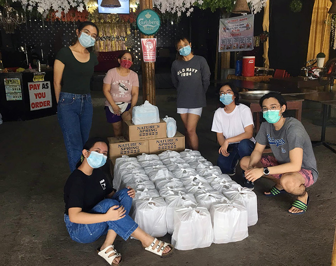 Paula May Adduru (bottom left), a United Methodist youth who works with the Barkadamayan organization, gets ready to serve meals and distribute relief packs to typhoon survivors in Ilagan on the Isabela province in the Philippines. Photo courtesy of Paula May Adduru.