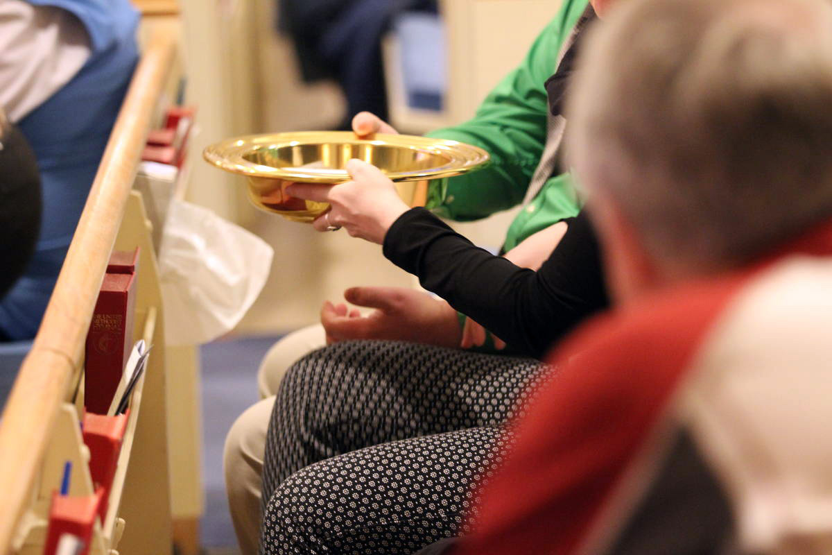 An offering plate is passed down the pew at Cathedral of the Rockies, a United Methodist church in Boise, Idaho. The General Council on Finance and Administration board surveyed U.S. conference treasurers to find out what impact potential church disaffiliations and church closures will have on the apportionment formula over the next four years. 2018 file photo by Mary Kienzle, United Methodist Communications.