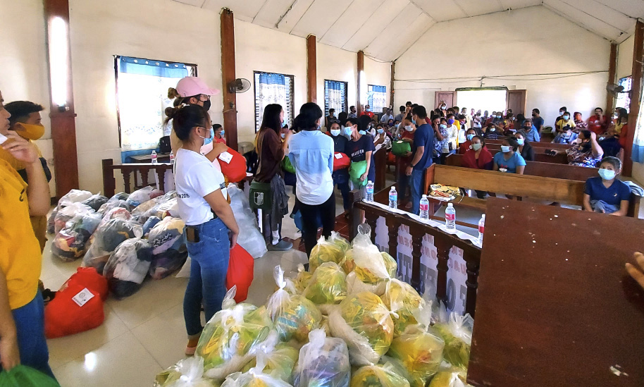 Trixia Son U. Acdal and her United Methodist Youth Fellowship team in the Northern Philippines Conference prepare to distribute relief packages at San Jose United Methodist Church in Baggao, Philippines, on the province of Cagayan. The region was hard hit by Typhoon Vamco. Photo courtesy of Trixia Son U. Acdal