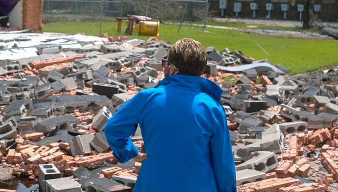 Bishop Cynthia Harvey surveys the rubble in front of University United Methodist Church in Lake Charles, La., after Hurricane Laura destroyed the nursery and an office wall. The church, which was hard hit by Hurricanes Laura and Delta, has been meeting at First United Methodist Church and will hold a service there on Dec. 23. Photo by Todd Rossnagel, Louisiana Conference.