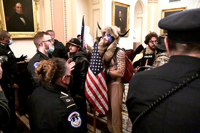 Police confront supporters of President Donald Trump as they demonstrate on the second floor of the U.S. Capitol in Washington near the entrance to the Senate after breaching security defenses on January 6. Photo by Mike Theiler, REUTERS.