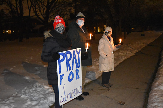 People at First United Methodist Church in Arlington Heights, Ill., hold candles during a prayer vigil in reaction to violence at the U.S. Capitol. Photo by Anne Marie Gerhardt, Northern Illinois Conference.