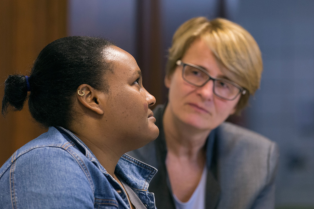 The Rev. Susanne Nießner-Brose (right) listens while a 27-year-old Sudanese woman who asked that she be called Fatima relates her story of fleeing Sudan to seek religious freedom in Europe. She was taking asylum in 2017 at the United Methodist Church of the Redeemer in Bremen, Germany, where Nießner-Brose is pastor, and was later accepted as a refugee. File photo by Mike DuBose, UM News.