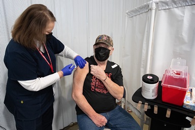 Stephen Saucerman receives a COVID-19 vaccination from volunteer nurse Jackie Smith, RN, at Community United Methodist Church in Vincennes, Ind. Photo by Mike DuBose, UM News. Stephen Saucerman receives a COVID-19 vaccination from volunteer nurse Jackie Smith, RN, at Community United Methodist Church in Vincennes, Ind. Photo by Mike DuBose, UM News.