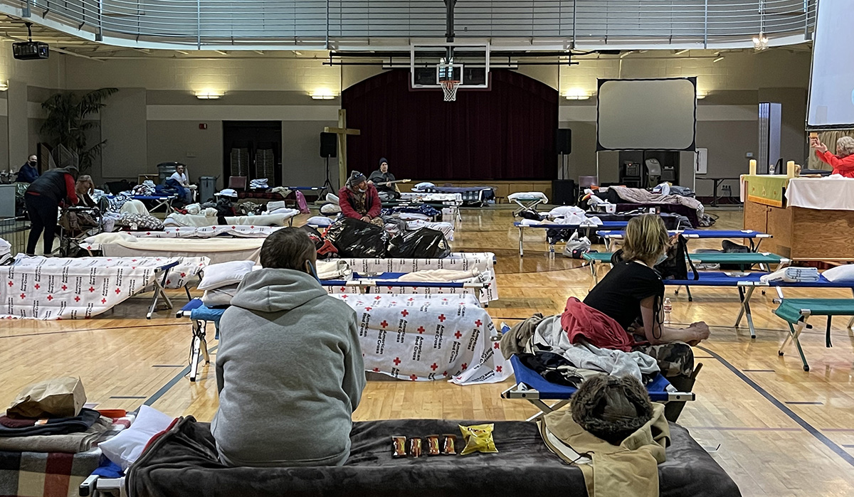 People seeking shelter from snow and bitter cold are offered Holy Communion in the gymnasium at First United Methodist Church in Hot Springs, Ark. The church is operating the warming shelter in cooperation with the local Red Cross. Photo by Cindy English.