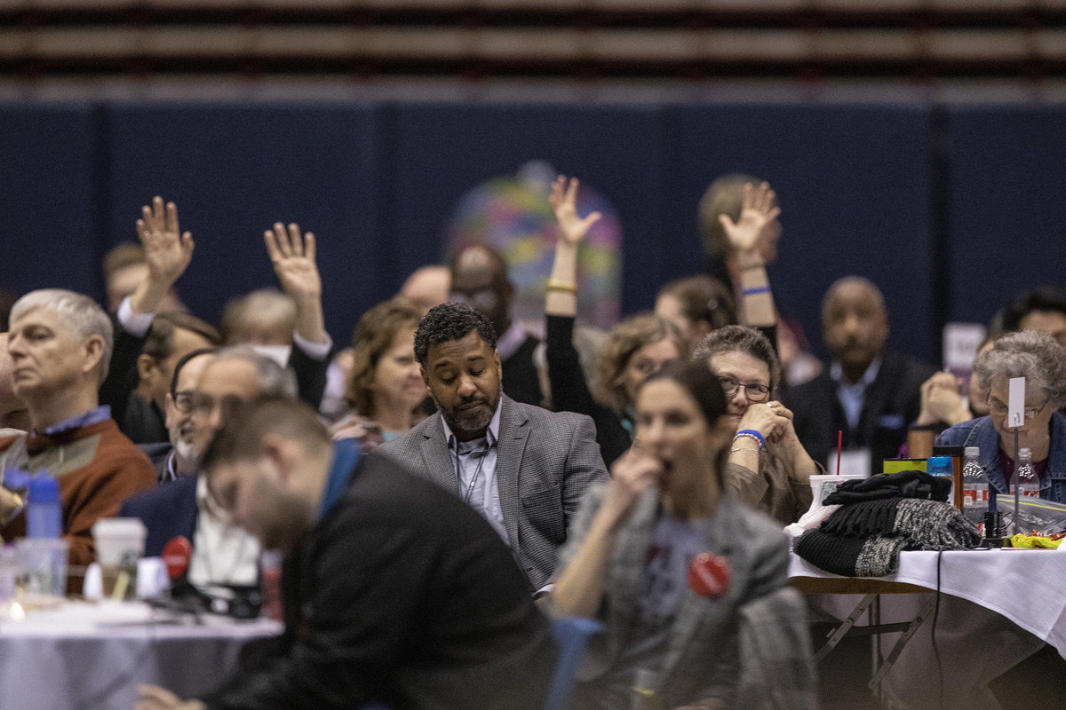 Delegates raise their hands during a session of the 2019 United Methodist General Conference in St. Louis. The coronavirus pandemic has led organizers to postpone General Conference again to 2022, leaving delegates with mixed emotions. File photo by Kathleen Barry, UM News.