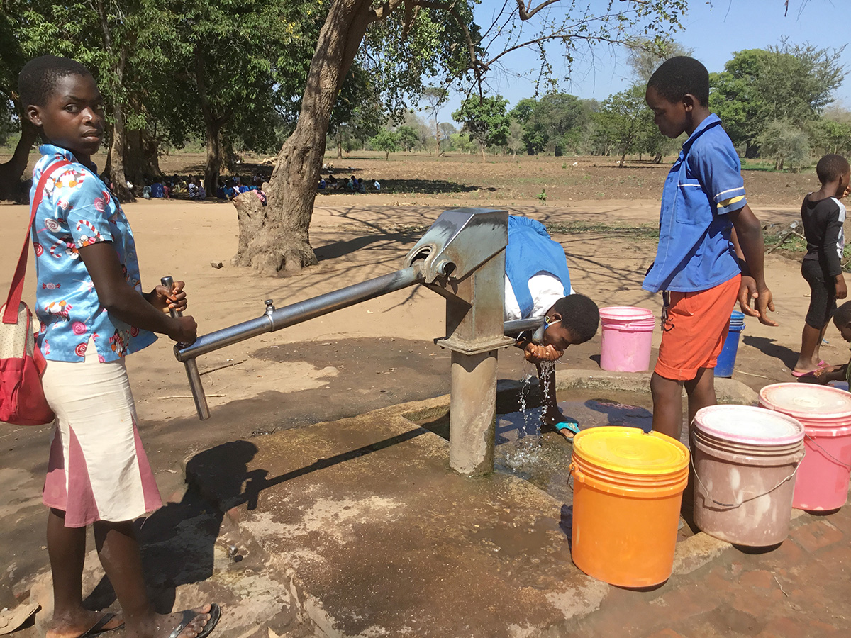 Schoolchildren drink from a borehole at Kalumba Primary School in Mangochi, Malawi, in September 2020. The borehole was drilled by the Malawi government. In response to water scarcity in this east African country, United Methodist Church of the Resurrection in Leawood, Kan., has helped fund the drilling of more than 80 boreholes since September. Photo by Francis Nkhoma, UM News.