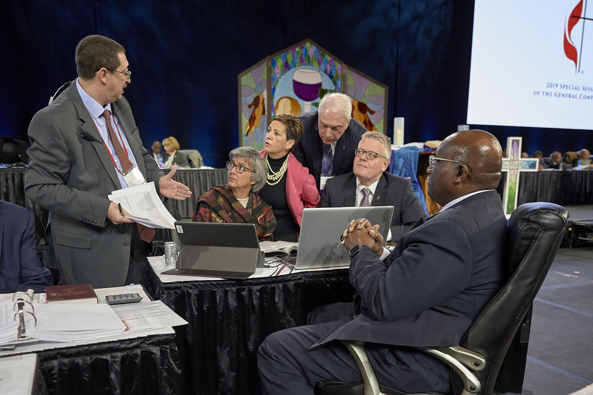 Following the announcement of a Judicial Council ruling that found several parts of the Traditional Plan unconstitutional, church officials confer during a pause in the Feb. 26 plenary session of the 2019 General Conference in St. Louis. Photo by Paul Jeffrey, UM News.