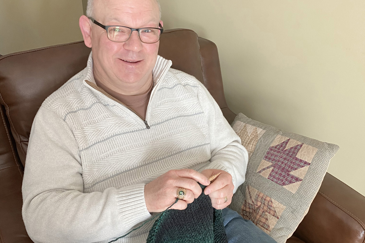 The Rev. Chad Parmalee has found knitting, especially making items for others, a way to relax amid the stresses of pandemic ministry. Parmalee leads Chapel Hill United Methodist Church in Battle Creek, Mich. Photo by Roschenne Parmalee.   
