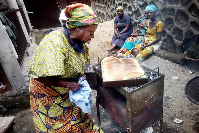 Omoyi Wandjaka teaches United Methodist women in Kivu, Congo, how to make bread to generate income for their families. Photo by Philippe Kituka Lolonga, UM News.
