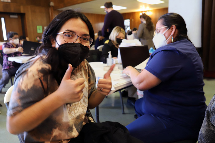 Alyssa Underwood gives two thumbs up during an Oklahoma Indian Missionary Conference COVID-19 vaccination event at Mosaic United Methodist Church in Oklahoma City, Okla.  Underwood, a senior in high school and a member of the Comanche Nation of Oklahoma, is looking forward to being able to attend in-person classes again. She is the daughter of Ginny Underwood, who contributed to this report. Photo by Ginny Underwood.