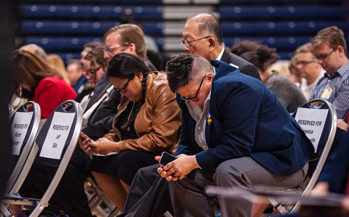 The Rev. Jessica Winderweedle (right) joins in prayer with other members of the Greater New Jersey Way Forward Team during an Oct. 26, 2019 special session of their annual conference at Brookdale Community College in Middletown, N.J. The United Methodist Judicial Council has issued five decisions related to the bishop’s rulings of law from that session. File photo by Corbin Payne.