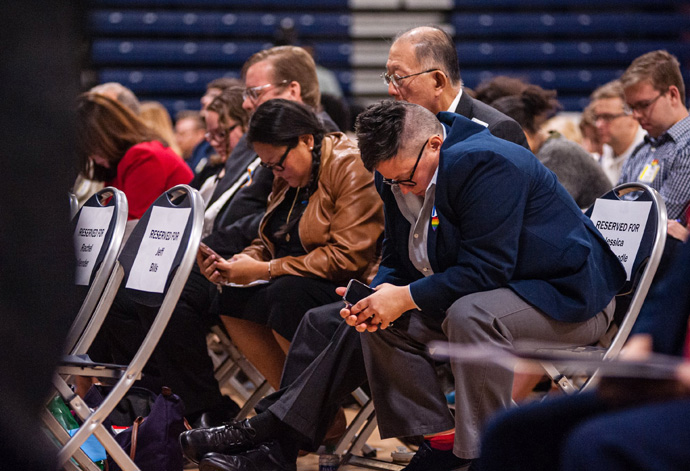 The Rev. Jessica Winderweedle (right) joins in prayer with other members of the Greater New Jersey Way Forward Team during an Oct. 26, 2019 special session of their annual conference at Brookdale Community College in Middletown, N.J. The United Methodist Judicial Council has issued five decisions related to the bishop’s rulings of law from that session. File photo by Corbin Payne.