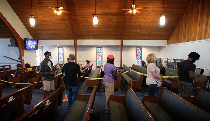 Patients form a line in the church sanctuary as they wait to receive a COVID-19 vaccination at St. Mark’s United Methodist Church in Charlotte, N.C. Those who have already received their dose wait in the background while being monitored for any possible side effects. Photo by Mike DuBose, UM News.