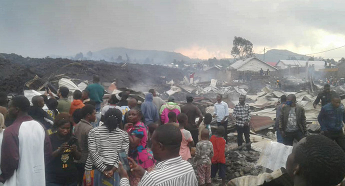 Residents of the Buhene neighborhood of Goma, Congo, survey the damage to their homes after the Mount Nyiragongo volcano erupted, killing at least 15 people. Photo by Philippe Kituka Lolonga, UM News.