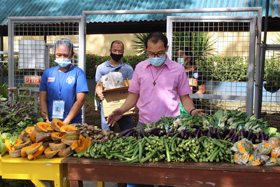 The Rev. Estelito Binuya Jr., chaplain at Harris Memorial College in Taytay, Philippines, prays for the offerings for the day at the Edukasyon sa Pagpapakatao students’ community food pantry. More than 500 needy families benefited from the three-day ministry at Harris Memorial College. Photo courtesy of Harris Memorial College.