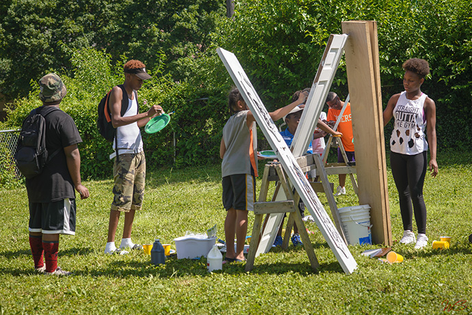 Indianapolis artists paint doors for use in a 2016 exhibit, “Perception: What’s Behind the Door?” The exhibit was an outreach by The Learning Tree, which was founded by DeAmon Harges to use assets within a community to improve neighborhoods. Photo by WildStyle DaProducer.