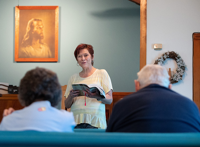 Pastor Laura Vincent reads the Scripture lesson during worship at Oakton United Methodist Church outside Clinton, Ky. Photo by Mike DuBose, UM News.